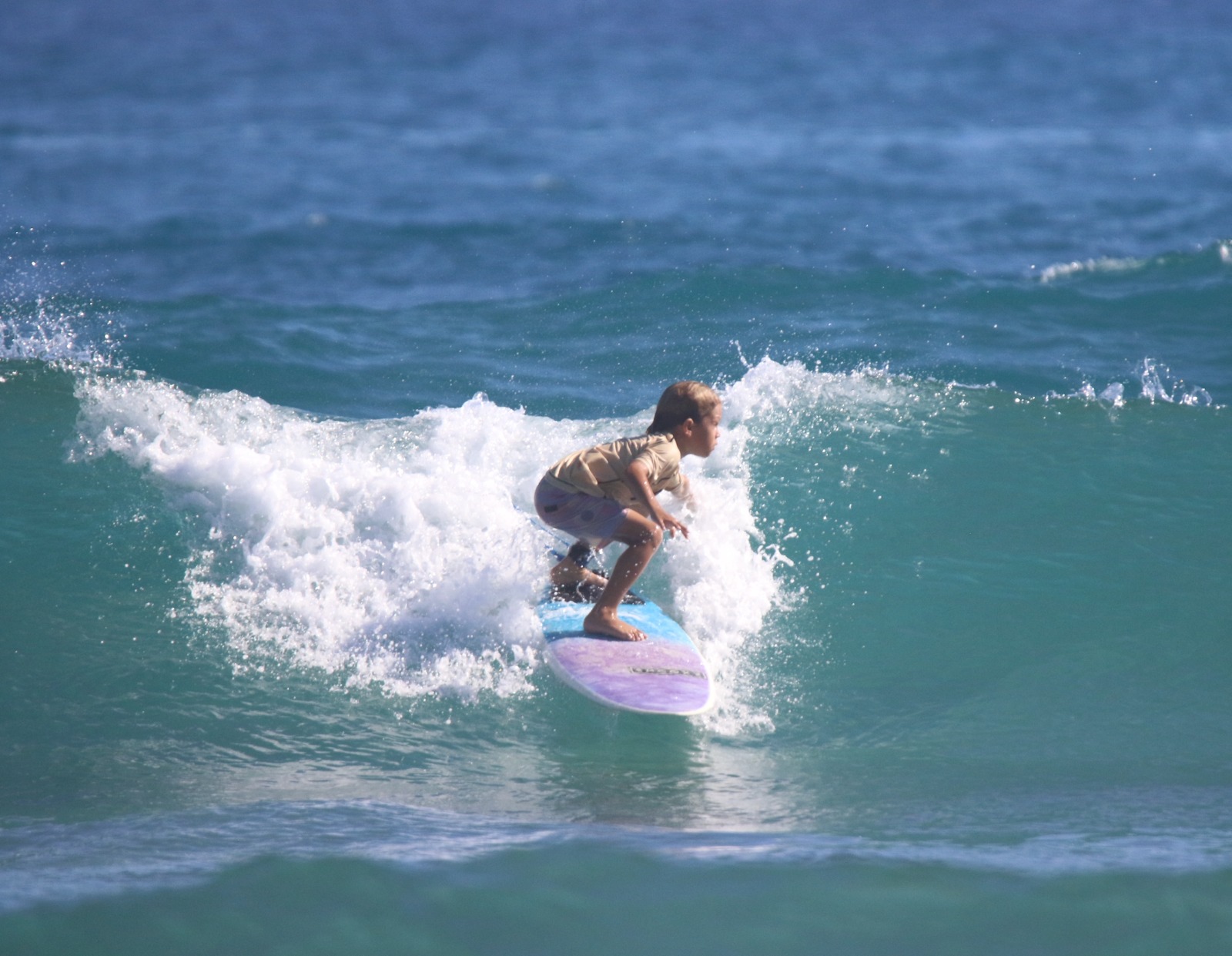 A young surfer riding a wave